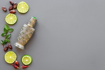 Silver bottle of arabian oud perfume with ingredients