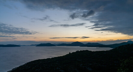 sunset on the Adriatic Highway in Croatia with a view of the coast and silhouettes of islands in the distance