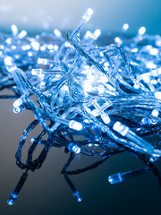 blue white garland with small led bulbs on dark background