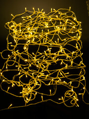 yellow garland with small led bulbs on a dark background