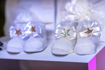 New year 2022 baby shoes on a white wooden background. Front view. Flat lay.
