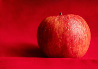 close up fresh red apple on red background