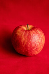 close up fresh red apple on red background