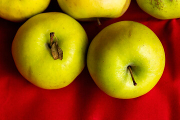 green apples close up on red background