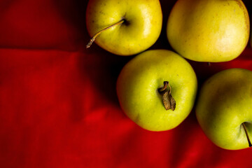 green apples close up on red background