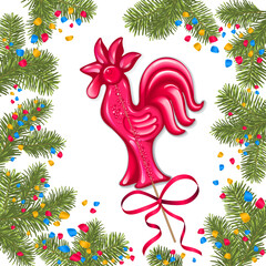 Red lollipop in the shape of a cockerel around branches of a Christmas tree and confetti on a white background.