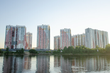 New buildings on the banks of the Neva River in the city of St. Petersburg. View from the water on a summer sunny day.