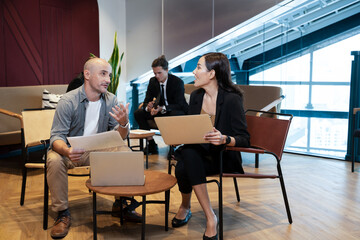 Group of coworkers interacting in the office,Business team people discussing documents and ideas at meeting.