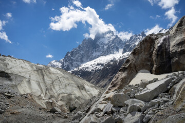 A view of the mountain peaks and clouds at the Mer de Glace in Chamonix, France on a sunny summer day in the French Alps