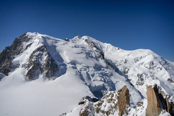 A view of the French Alps, Swiss Alps, and Italian Alps on a sunny summer day from the Aiguille du Midi near Mont Blanc in Chamonix, France