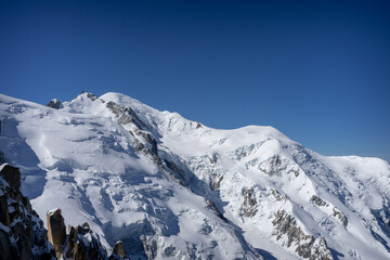 A view of the French Alps, Swiss Alps, and Italian Alps on a sunny summer day from the Aiguille du Midi near Mont Blanc in Chamonix, France