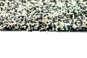 Background made from a macro photo of the inside of the filter with active carbon and water filtration pearls, isolated on a white background.