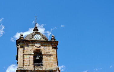 Fototapeta na wymiar Round dome of catholic church with clock on it in Legazpi, Basque Country, Spain