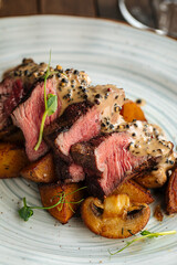 Gourmet beef medallions dish with potatoes and mushrooms