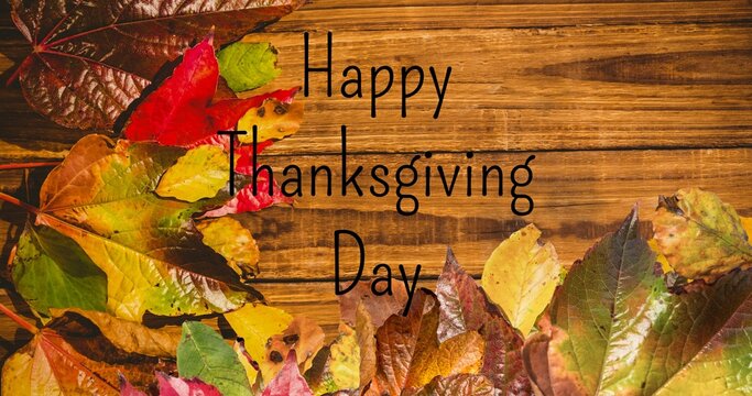 Digital composite image of happy thanksgiving day text and autumn leaves with copy space on table