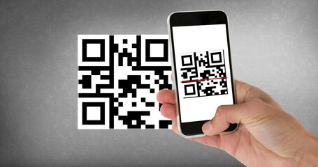 Cropped hand scanning qr code with smart phone with copy space on gray background