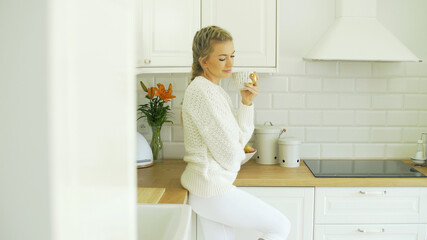 Fototapeta na wymiar Young attractive woman relaxing with tea at home.