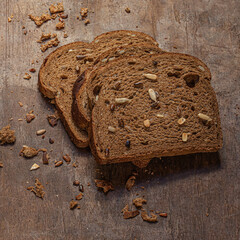 Sliced bread isolated on wooden background. Fresh Whole grain  Bread slices close up. Bakery,  traditional food concept. Top view.
