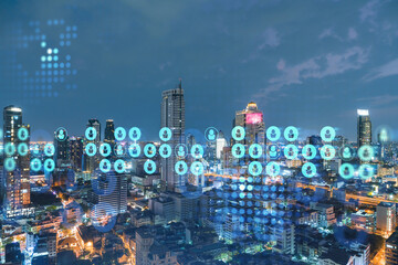Glowing social media icons on night panoramic city view of Bangkok, Southeast Asia. The concept of networking and establishing new connections between people in businesses. Double exposure.