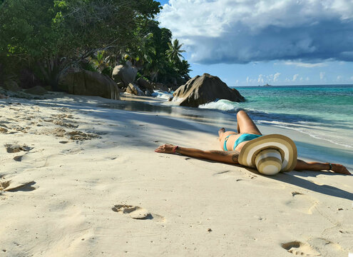 beautiful woman laying on the beautiful beach Patratan in La dique Seychelles