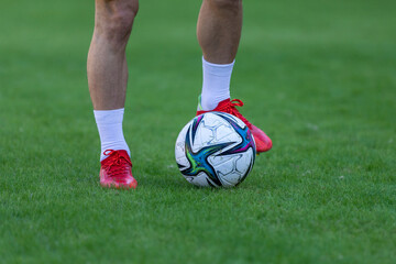 Legs of an unrecognizable football player with the ball