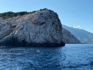Sea and rock background. Rock and blue sea with clear sky. Seaside travel destination background image