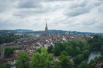 Fototapeta premium A view of Bern, Switzerland from the hill of Rosengarten (Rose Garden), with the red roofs of the city below - Aargauerstalden Viewpoint