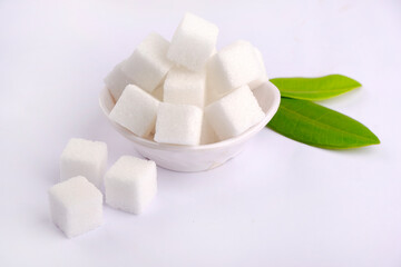 Refined sugar cubes on white background.