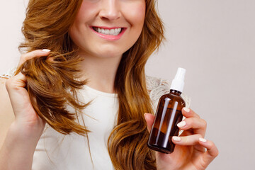 Woman applying hair cosmetic