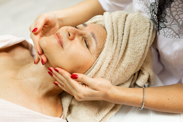 Fototapeta na wymiar Elderly Caucasian Female On Facial Massage 