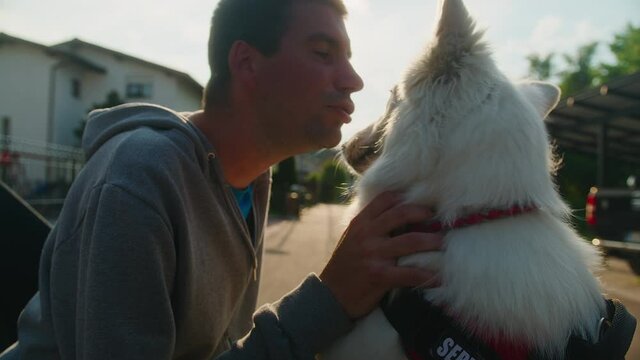 Middle shot of a young Caucasian disabled man and his service dog, love and affection moment.
