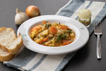 Chopped colorful vegetables on rustic kitchen table with vegetarian cooking ingredients and tools . Healthy and clean food cooking and eating concept.