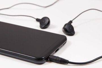 Mobile phone, smartphone with connected headphones. Using electronics equipment