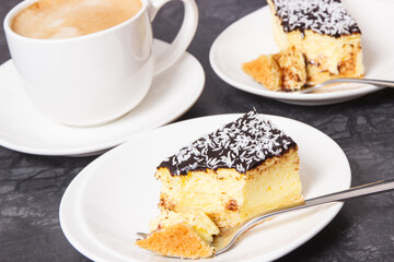 Fresh baked cheesecake and cup of white coffee. Delicious dessert