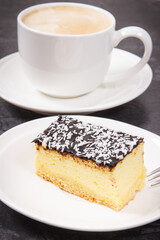 Coffee with milk and fresh baked cheesecake. Delicious dessert