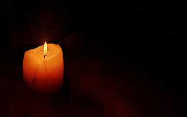 Funeral candle flame candlelight on dark background