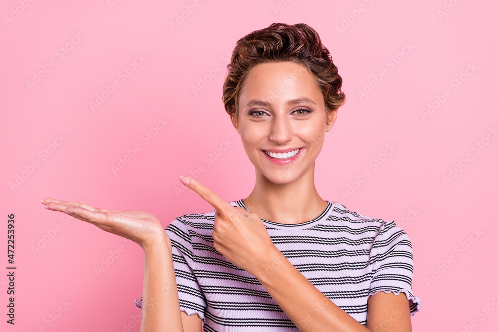 Wall mural Photo of cool millennial short hairdo lady hold index empty space wear striped t-shirt isolated on pink color background