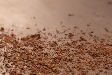 Background of Grated bitter chocolate powder cocoa on the table. Dark chocolate. Copyspace