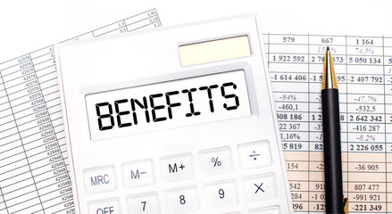 On the desktop there are reports, a white calculator with the text BENEFITS on the scoreboard and a...