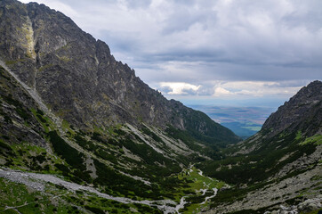Fototapeta premium Amazing landscape with majestic rocky mountains under low grey sky in High Tatras, Slovakia