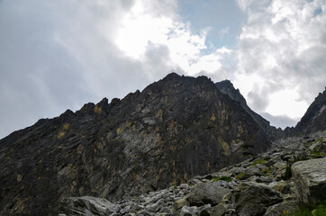 Amazing landscape with majestic rocky mountains under low grey sky in High Tatras, Slovakia