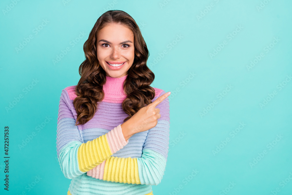 Wall mural Photo of funky brunette millennial lady promote empty space wear violet sweater isolated on teal color background