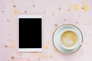 Digital tablet mock up, cup of espresso on pastel pink with pearls abstract woman background. Coffee break, online shopping, studying, sales concept. Internet application template. Top view, flat lay