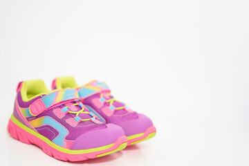 color kid  sneakers shoes with shoelace on floor side view soft focus copy space