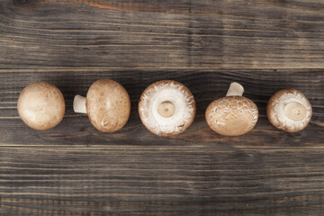 Mushrooms on wooden background.