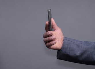 businessman with mobile phone on grey background stock photo