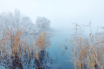 Magnificent frosty morning fog over the lake in November.