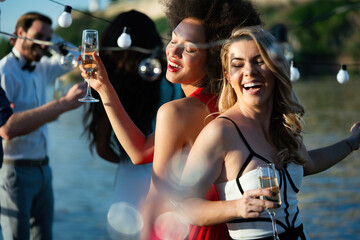 Group of happy friends drinking champagne and celebrating New Year © NDABCREATIVITY