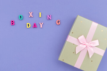 Inscription boxing day in wooden letters on purple background