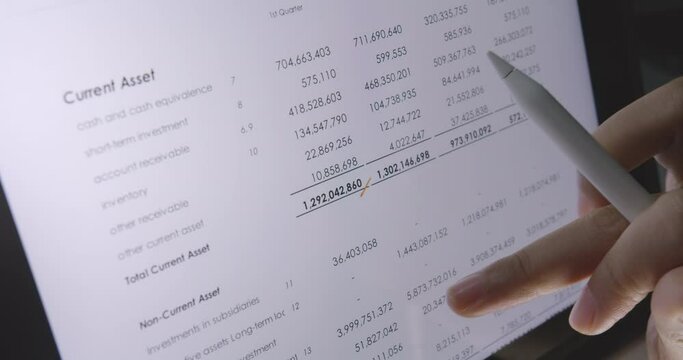 Bank loan auditor or trader consult use digital pen write on tablet check data review number on ledger asset balance sheet annual report. Budget control learning for risk planner work MBA tax study.